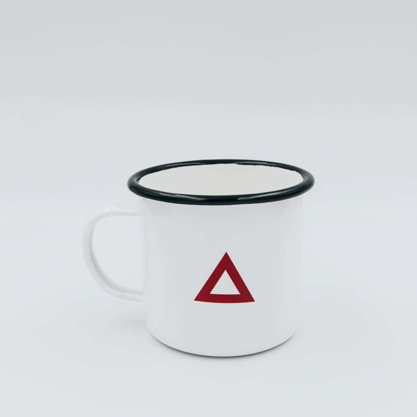 Classic enamel mug with a red triangle design and black rim, perfect for hot beverages.
